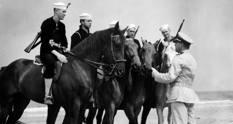 Members of Coast Guard partol on horseback