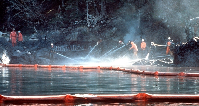 Prince William Sound, AK (Mar. 28)--Workers steam blast rocks soaked in crude oil from the leaking tanker Exxon Valdez. The Exxon Valdez ran aground on Bligh Reef in Prince William Sound, Alaska, March 23, 1989 spilling 11 million gallons of crude oil, which resulted in the largest oil spill in U.S. history. 