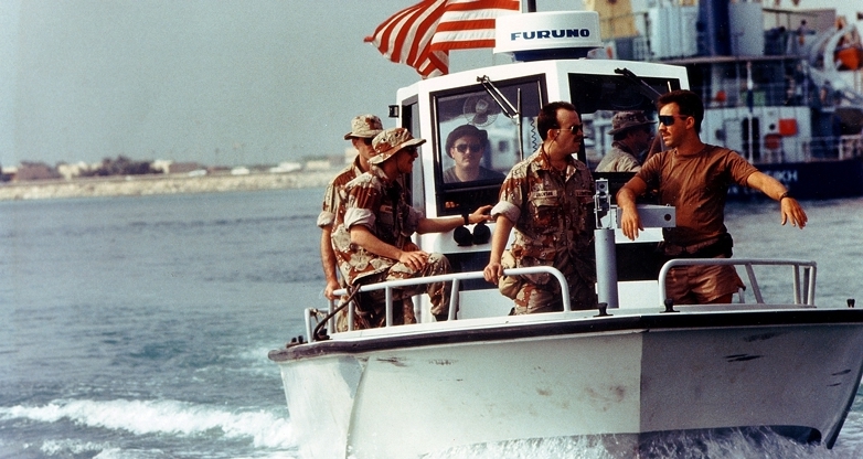 Members of U.S. Coast Guard Port Security Unit 302 patrol the harbor aboard a Navy harbor patrol boat during Operation Desert Shield
